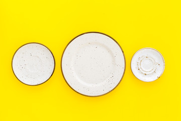 Mockup with plates. Empty ceramic plates on yellow background top view copy space