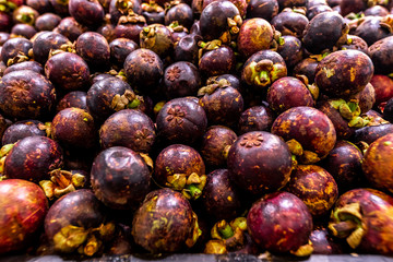 Fresh organic exotic fruit mangosteen on a local food market, Bali island. Mangosteen background.