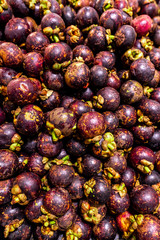 Fresh organic exotic fruit mangosteen on a local food market, Bali island. Mangosteen background.