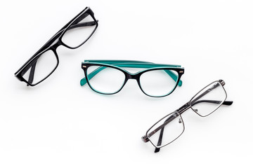 Set of glasses with transparent lenses on white background top view space for text
