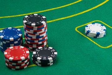 on the green table, for gambling for money, there are cards and chips for playing in the casino