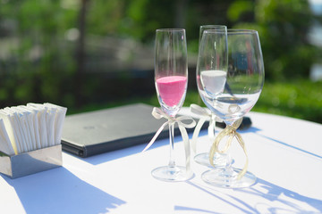 color sand in wine glass cup for let couple in wedding ceremony pour into big one together, it's sign of love