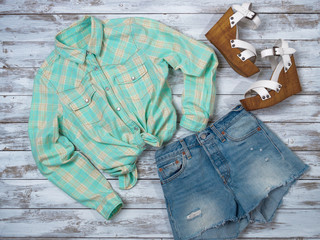 Womens clothing, shoes (plaid shirt, denim shorts, wedge sandals). Fashion outfit, spring summer collection. Shopping concept. Flat lay, top down view