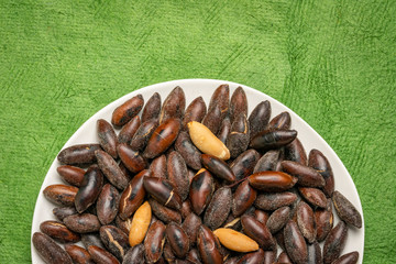 roasted baru nuts on a black plate