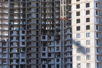Fototapeta na wymiar Under construction apartment building and residential real estate, close up view