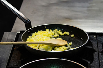 Chef cooking food in the kitchen, stir fried vegetables in the pan
