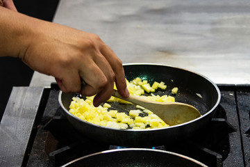 Chef cooking food in the kitchen, stir fried vegetables in the pan