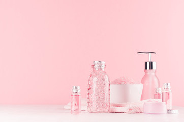 Different skin care products on girlish elegant pink pastel background with copy space.