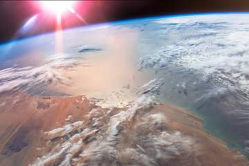 The Sun's glint radiates off the Atlantic Ocean above the African Mauritania. Elements of this image furnished by NASA.