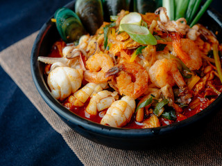 Korean food, Jampong, spicy noodle seafood in black bowl for korean menu style.