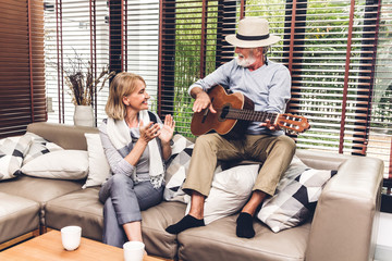 Senior couple relaxing and talking together sitting on sofa in living room at home.Retirement couple concept