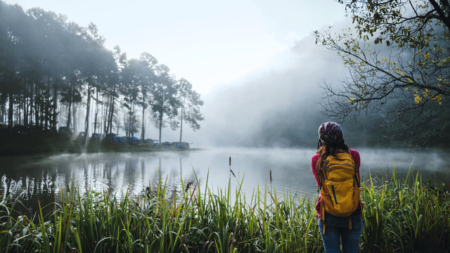 Young women travel to take pictures of beautiful natural forests, Pang Ung and pine forests in Mae Hong Son province, Thailand.