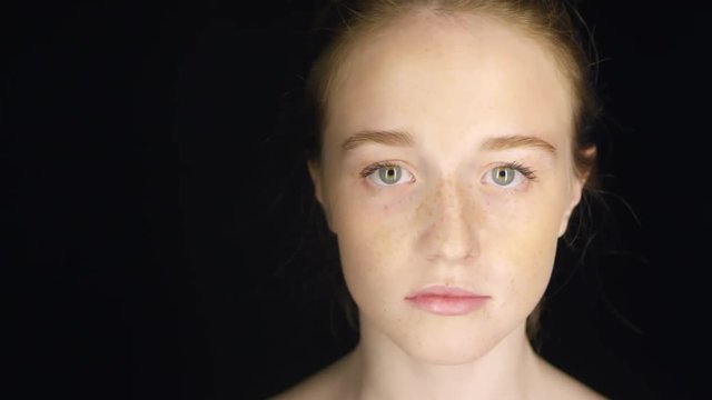 Close up of face of young naked ginger woman