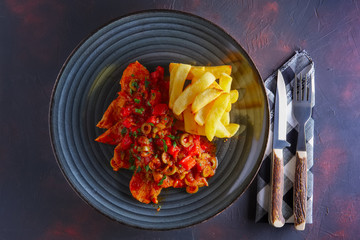 Portuguese  goulash with tomato and olives sauce and fried potato