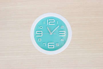 Clock on wooden background 