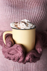Woman holding cup of hot cacao drink, closeup