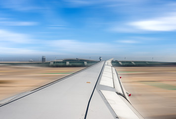 Fototapeta na wymiar Airplane running on the airport runway - Blurred motion