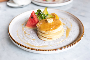 Close up of delicious pancakes with fresh fruits.