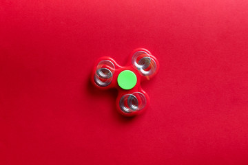 Stroboscopic photo of moving spinner on color background