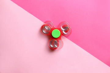 Stroboscopic photo of moving spinner on color background