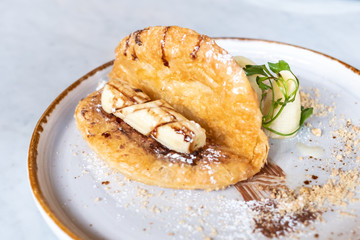 Delicious Roti and Nutella on the plate in restaurant, elegant dessert.