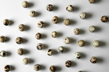 Raw quail eggs on white background
