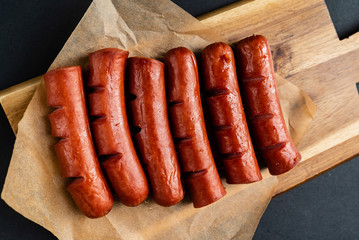 grilled sausages on the wooden board