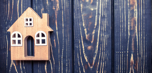 House symbol on a brown wooden background 