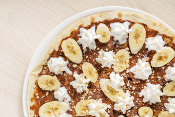 sweet pizza with chocolate paste and bananas