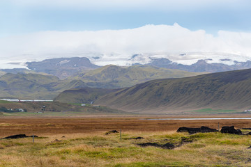 beautiful landscape view in Iceland during road trip. Blue sky, mountain and green field