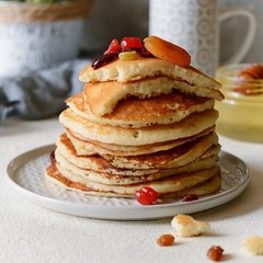 Sweet Homemade Stack of Pancakes with  honey for Breakfast  on a gray background. Sweet beautiful breakfast. Brunch. Family Breakfast. Concept for cafes, restaurants, fast food outlets, bars