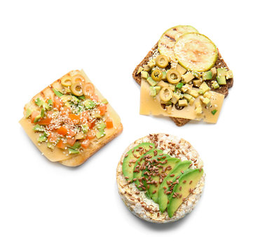 Different tasty sandwiches with avocado on white background