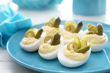 Tasty deviled eggs on plate, closeup