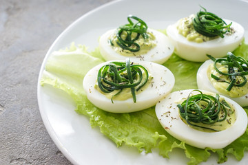 Tasty deviled eggs on plate, closeup