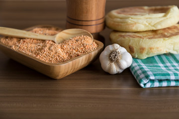 Fototapeta na wymiar Tarhana soap in the wooden plate with traditional spoon and garlic for kitchen and food photo concept.