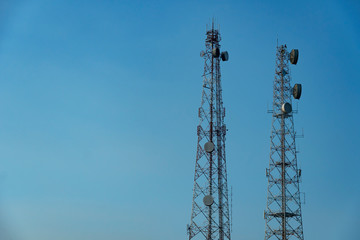high two towers of broadcast telecommunication technology with blue sky background