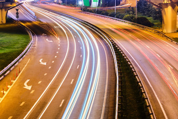 Highway and overpass with cars and trucks, interchange, two-level road junction in the big city. Top view.