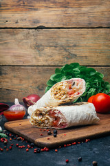 Doner kebab (shawarma or doner wrap). Grilled chicken on lavash (pita bread) with fresh vegetables...