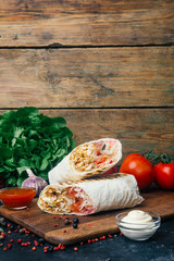 Doner kebab (shawarma or doner wrap). Grilled chicken on lavash (pita bread) with fresh vegetables...