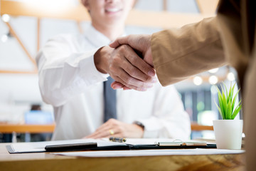 Negotiating business, Two confident business man shaking hands with partners together after...