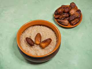 Healthy breakfast food. Oatmeal porridge with date