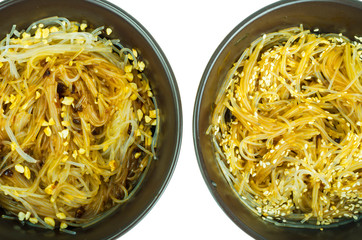 Hot glass noodles with sauce, peanuts, sesame.