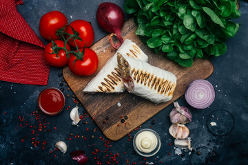 Doner kebab (shawarma or doner wrap). Grilled chicken on lavash (pita bread) with fresh vegetables...