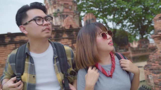 Traveler Asian couple spending holiday trip at Ayutthaya, Thailand, backpacker sweet couple enjoy their journey at amazing landmark in traditional city. Lifestyle couple travel holidays concept.