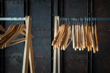 Empty wooden hangers hang on the wardrobe