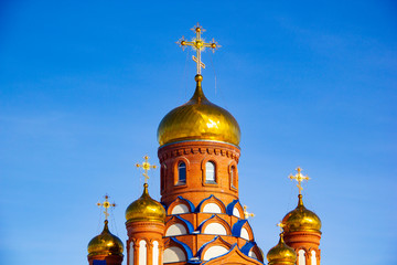 Fototapeta na wymiar Orthodox cross on the dome of the church against the blue sky