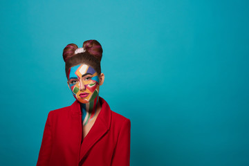 Stylish model posing with pop art make up on face.