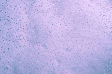 Beautiful texture of drops on the glass, tinted photo, background.