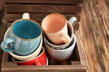 Wooden box with ceramic tea cups