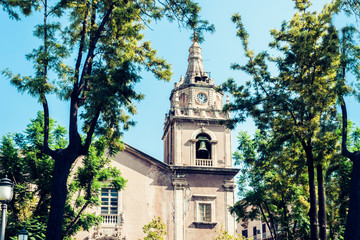 Facade of old cathedral on historical street of Catania, Sicily, Italy.